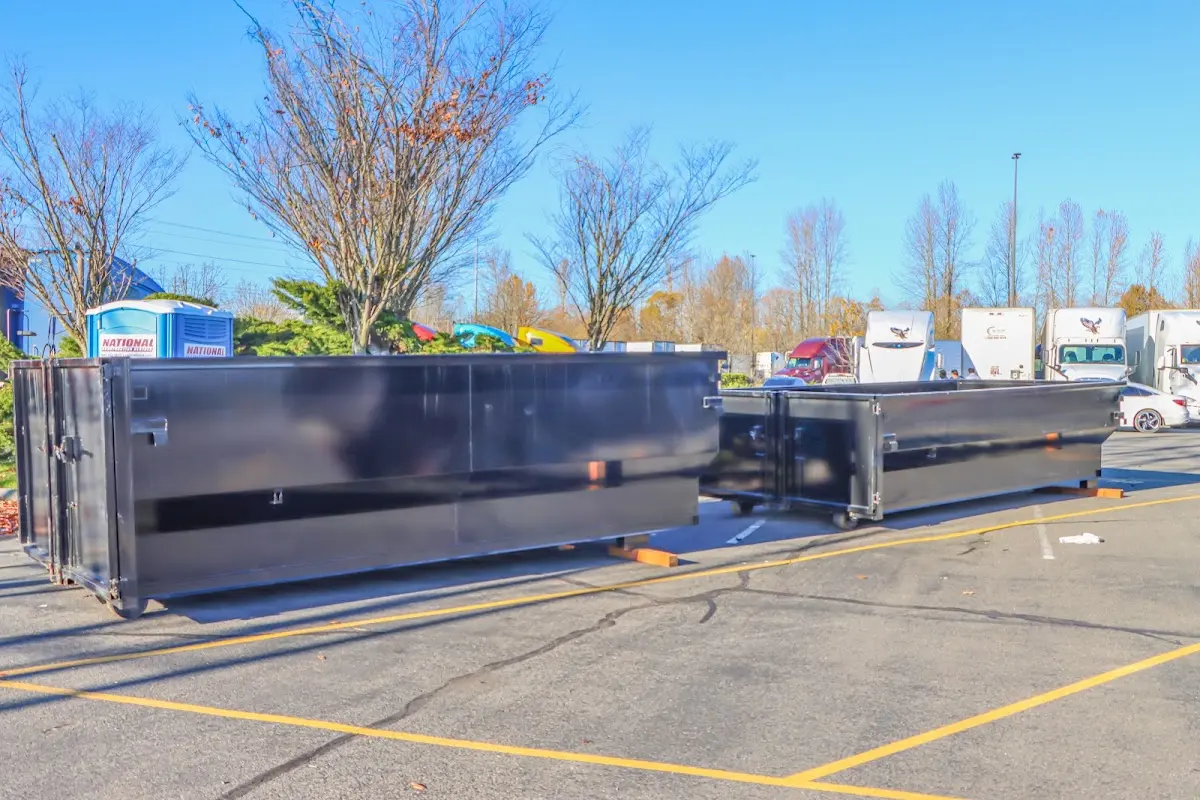 Professional dumpster rental service with roll-off container on residential driveway in Wheat Ridge